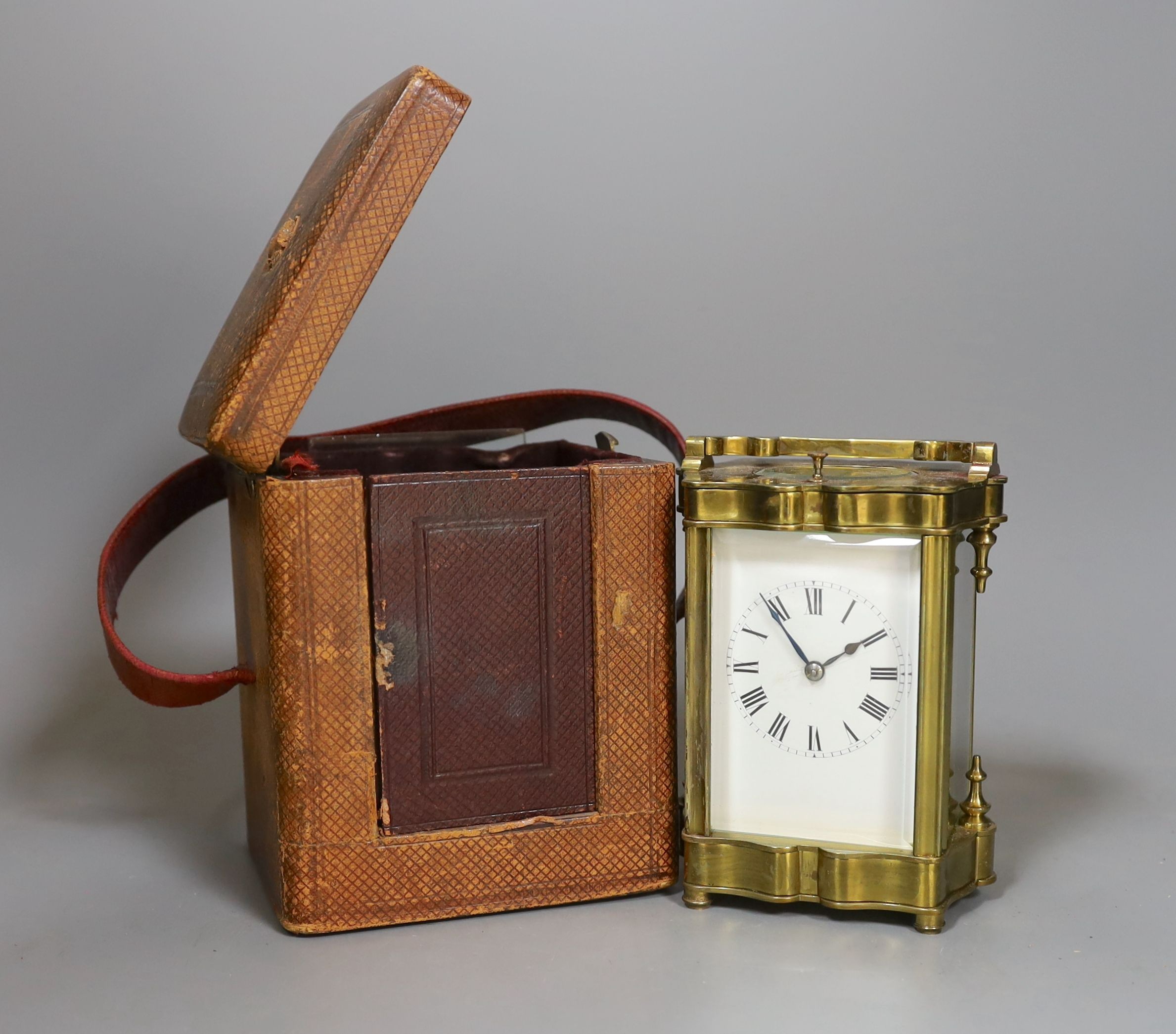 A cased brass repeating carriage clock, in case, 12 cms high.